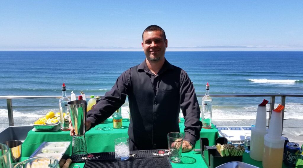 Male bartender standing behind the bar