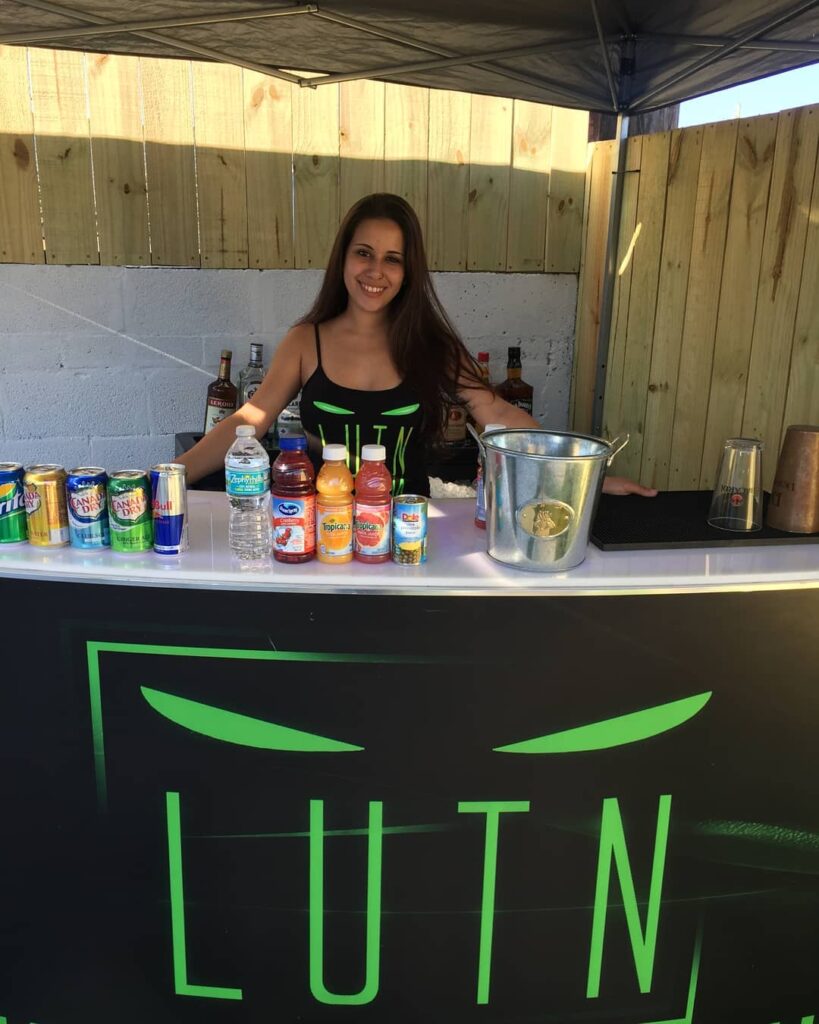 female bartender standing behind the bar